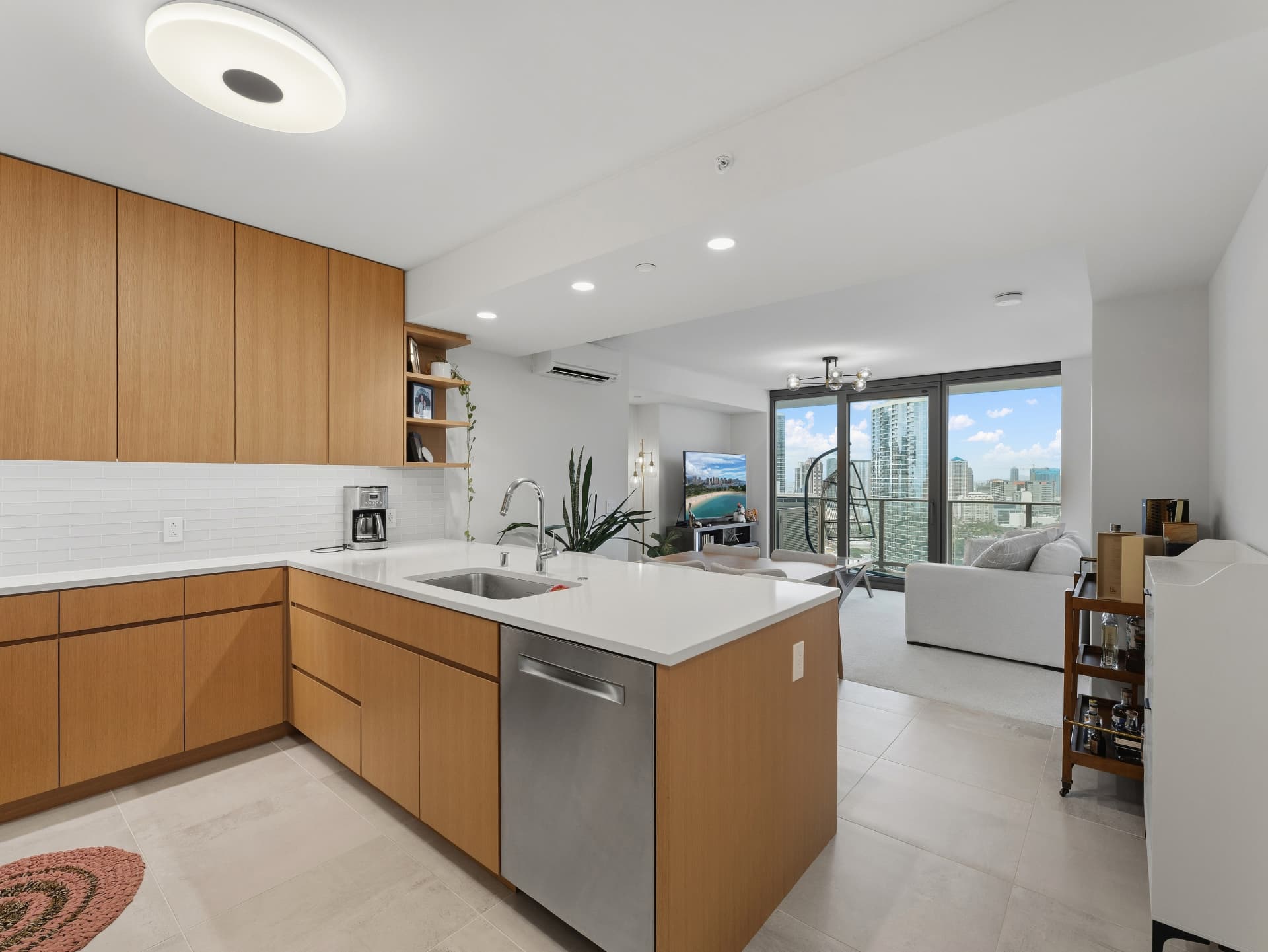 Kitchen looking across the island toward the living room and balcony city views