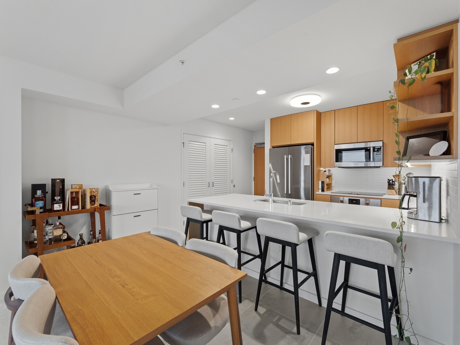 Dining table beside the kitchen island with bar seating